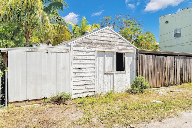 view of outbuilding with an outbuilding and fence