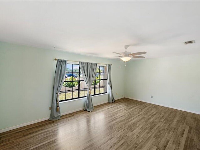 1821 SE Hanby Ave, Port Saint Lucie, FL 34952 - unfurnished room with wood finished floors, ceiling fan, and baseboards