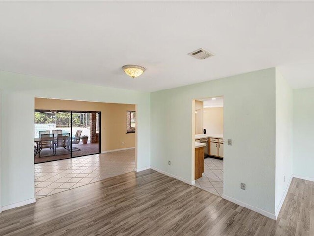 1821 SE Hanby Ave, Port Saint Lucie, FL 34952 - spare room featuring light wood finished floors and baseboards
