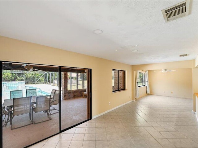 1821 SE Hanby Ave, Port Saint Lucie, FL 34952 - empty room featuring ceiling fan, healthy amount of natural light, and baseboards