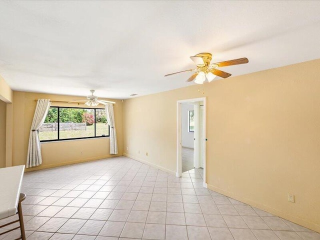 1821 SE Hanby Ave, Port Saint Lucie, FL 34952 - unfurnished room with ceiling fan, baseboards, and light tile patterned floors