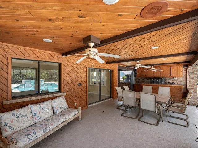 1821 SE Hanby Ave, Port Saint Lucie, FL 34952 - dining area with carpet flooring, healthy amount of natural light, a ceiling fan, wood walls, and wood ceiling with exposed beams