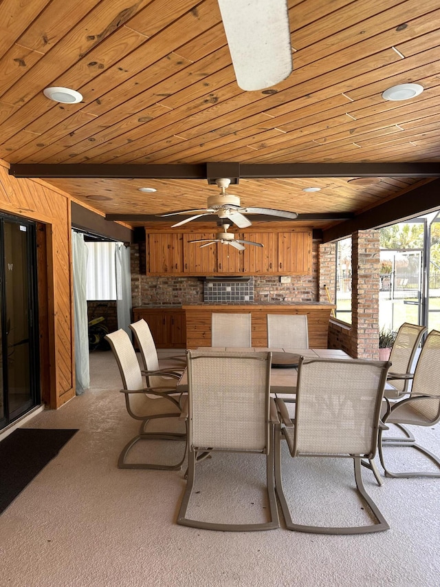 dining room with wooden ceiling, a ceiling fan, beamed ceiling, and carpet flooring