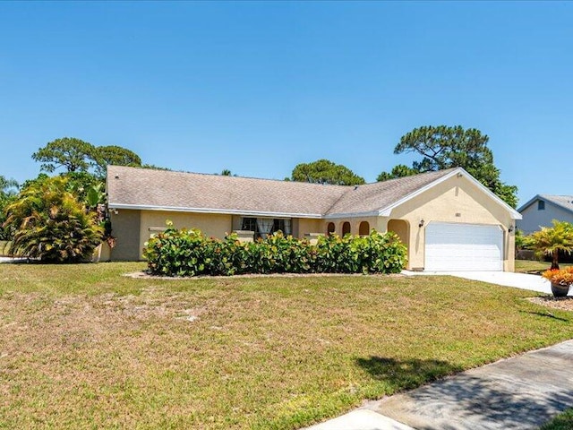 1821 SE Hanby Ave, Port Saint Lucie, FL 34952 - ranch-style house with a garage, a front yard, driveway, and stucco siding