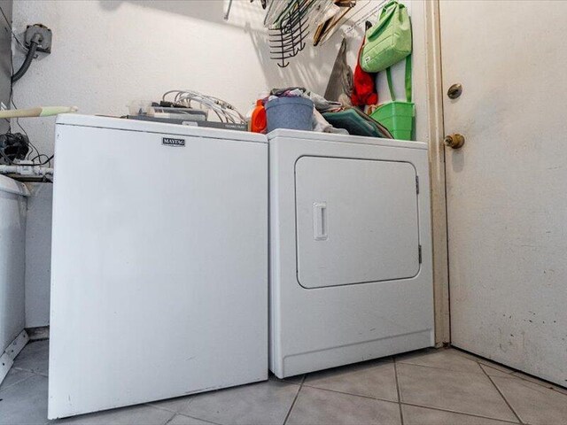 1821 SE Hanby Ave, Port Saint Lucie, FL 34952 - laundry area with washing machine and dryer and tile patterned flooring