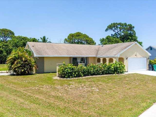1821 SE Hanby Ave, Port Saint Lucie, FL 34952 - single story home featuring an attached garage, driveway, a front lawn, and stucco siding