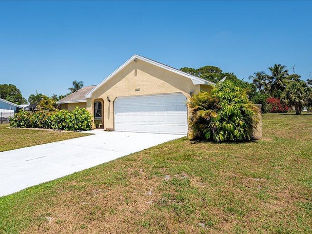 1821 SE Hanby Ave, Port Saint Lucie, FL 34952 - ranch-style house featuring a garage, driveway, a front lawn, and stucco siding