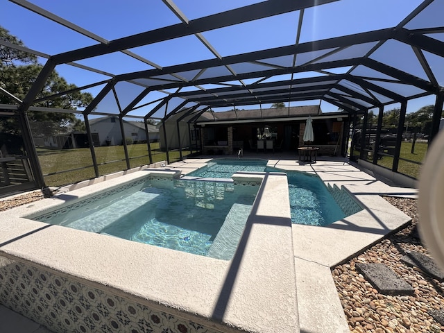 pool featuring glass enclosure and a patio area