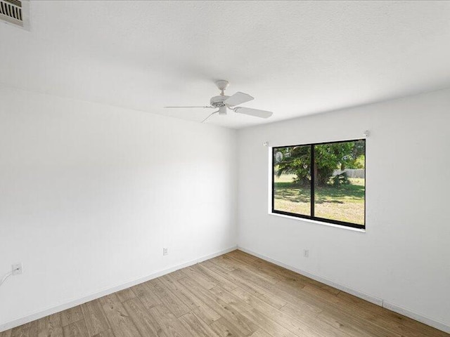 1821 SE Hanby Ave, Port Saint Lucie, FL 34952 - spare room with light wood finished floors, a ceiling fan, and baseboards