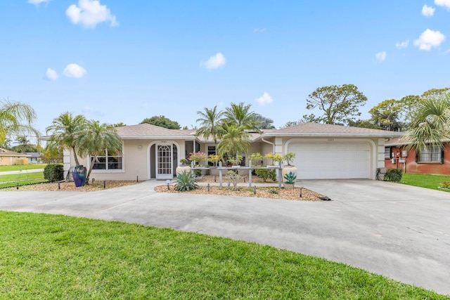 ranch-style house with driveway, a garage, a front lawn, and stucco siding