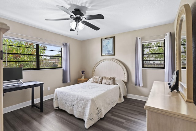 bedroom featuring dark wood finished floors, a ceiling fan, and baseboards