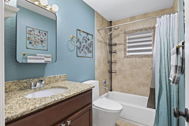 bathroom featuring toilet, a textured wall, shower / tub combo, and vanity