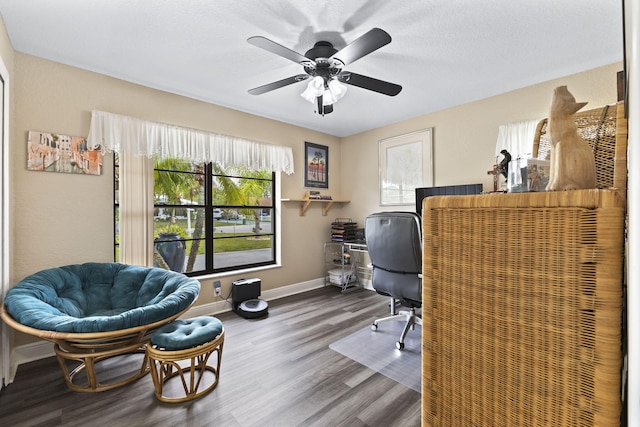 office area featuring ceiling fan, wood finished floors, and baseboards