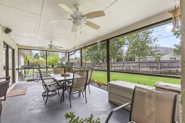 sunroom featuring a ceiling fan and plenty of natural light