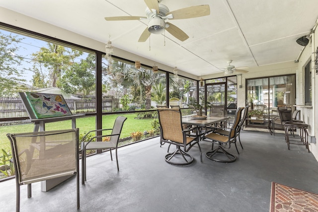 sunroom / solarium featuring a ceiling fan