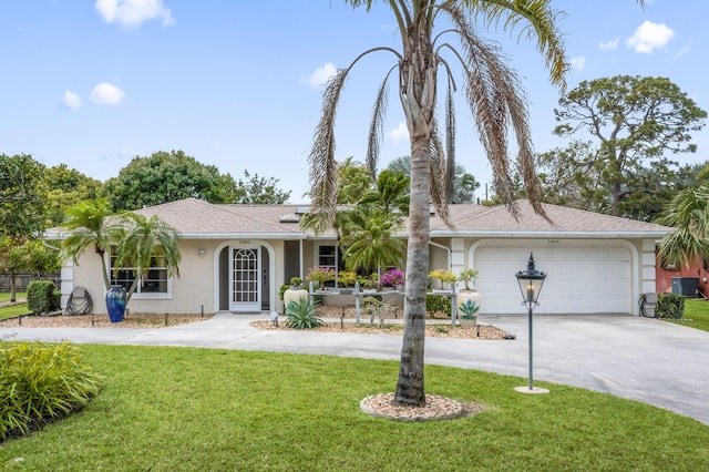 ranch-style house featuring a garage, concrete driveway, a front yard, and stucco siding