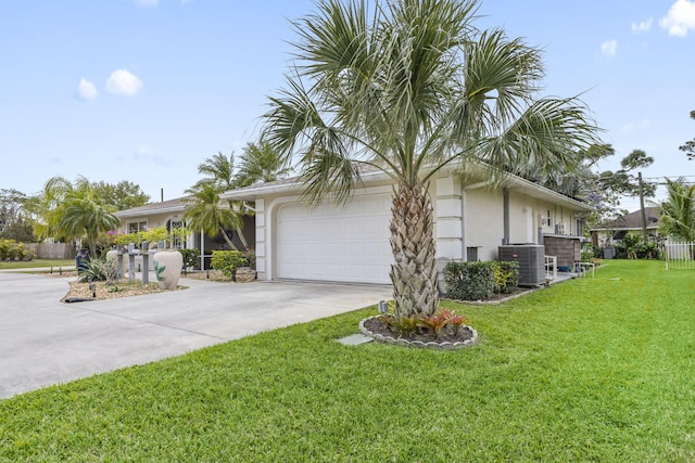 view of property exterior with an attached garage, central air condition unit, a yard, concrete driveway, and stucco siding