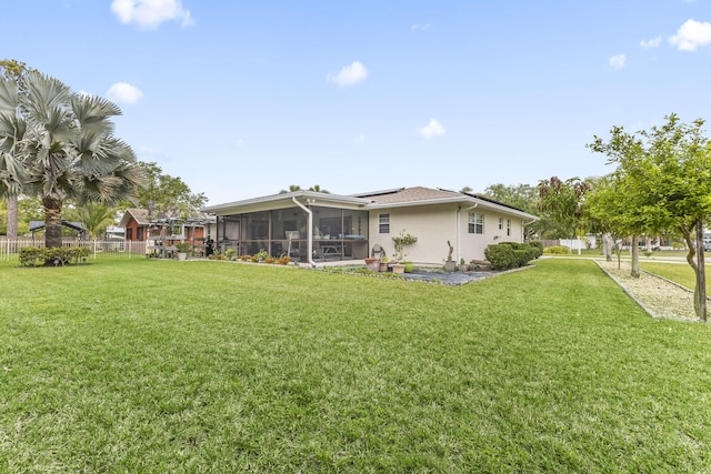 view of yard featuring a sunroom and fence