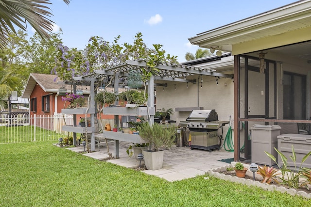 view of yard with a patio area, fence, a sunroom, and a pergola