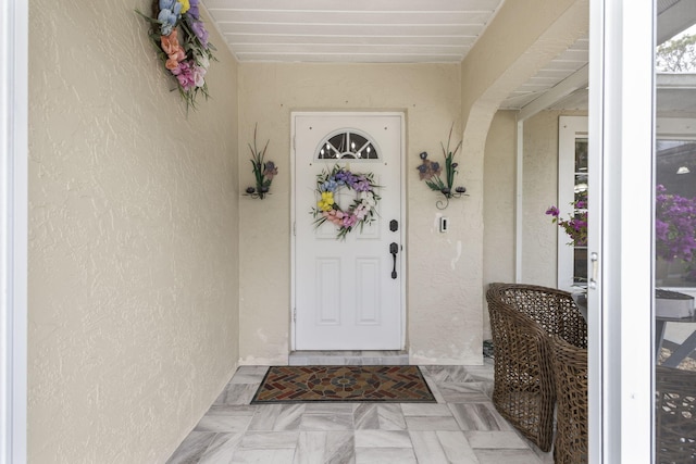 doorway to property with stucco siding