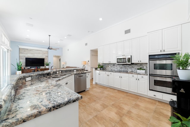 15730 Cedar Grove Ln, Wellington, FL 33414 - kitchen featuring backsplash, a sink, ceiling fan, visible vents, and appliances with stainless steel finishes