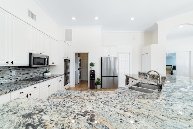 15730 Cedar Grove Ln, Wellington, FL 33414 - kitchen with visible vents, a sink, crown molding, and appliances with stainless steel finishes