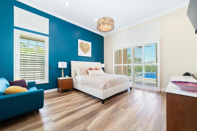 15730 Cedar Grove Ln, Wellington, FL 33414 - bedroom with baseboards, light wood-style flooring, multiple windows, and crown molding