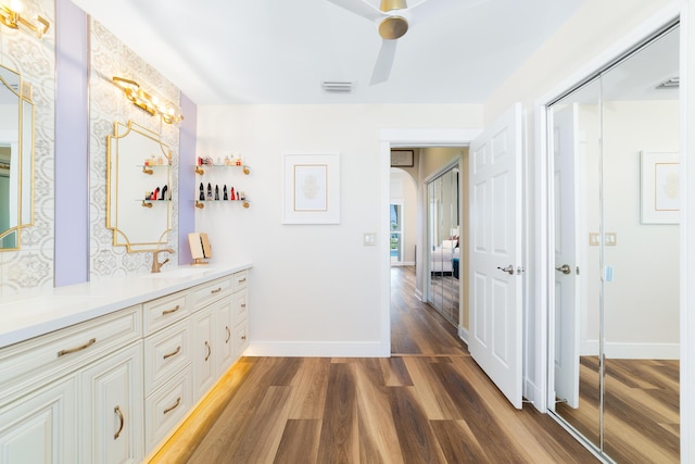 15730 Cedar Grove Ln, Wellington, FL 33414 - hallway with baseboards, visible vents, wood finished floors, and a sink