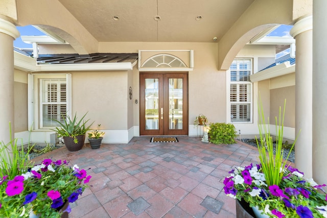 15730 Cedar Grove Ln, Wellington, FL 33414 - entrance to property featuring metal roof, a standing seam roof, stucco siding, french doors, and a patio area