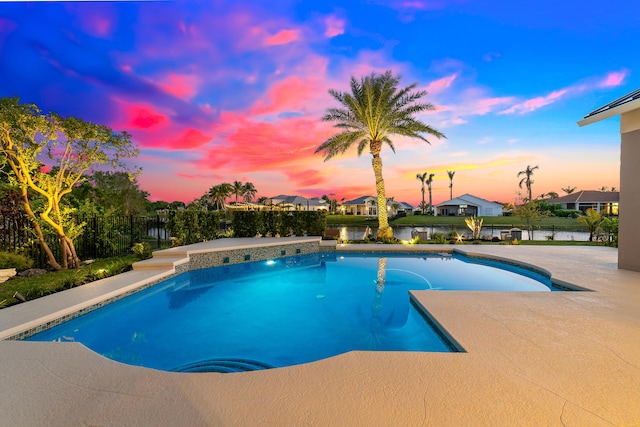 15730 Cedar Grove Ln, Wellington, FL 33414 - pool at dusk featuring fence, a fenced in pool, a patio area, and a residential view