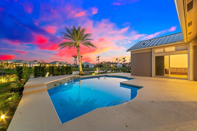 15730 Cedar Grove Ln, Wellington, FL 33414 - pool at dusk with a fenced backyard, a fenced in pool, a residential view, and a patio