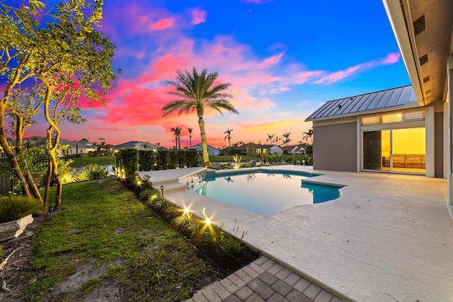 15730 Cedar Grove Ln, Wellington, FL 33414 - pool at dusk featuring a fenced in pool, a yard, and a patio area