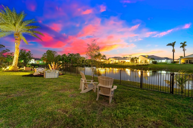 15730 Cedar Grove Ln, Wellington, FL 33414 - yard at dusk with a water view and a fenced backyard