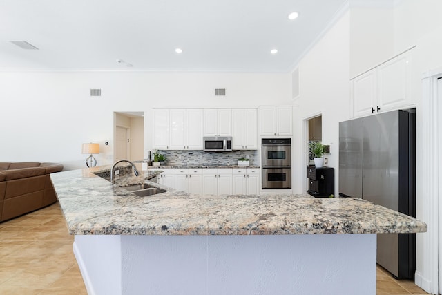 15730 Cedar Grove Ln, Wellington, FL 33414 - kitchen featuring tasteful backsplash, crown molding, stainless steel appliances, a sink, and visible vents
