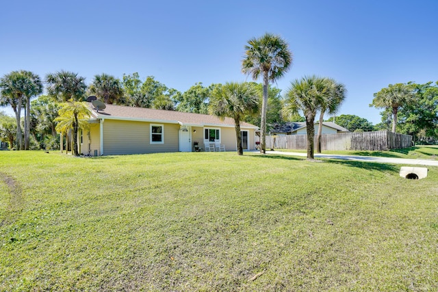 exterior space featuring a front lawn and fence