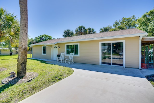 single story home with a front lawn, fence, and a patio