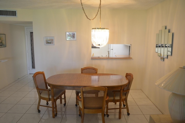 dining space with light tile patterned flooring and visible vents