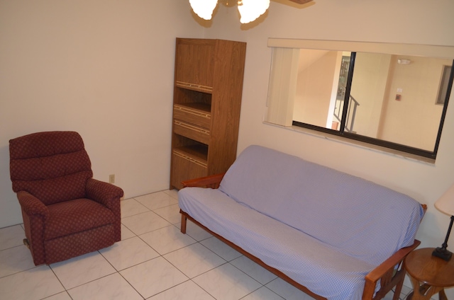 sitting room with ceiling fan and light tile patterned floors