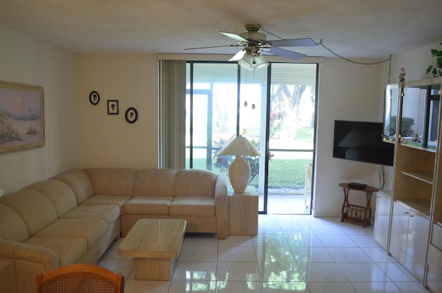 living room featuring ceiling fan, a textured ceiling, and light tile patterned flooring