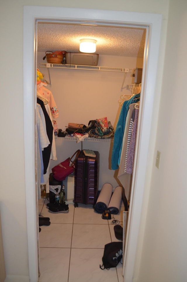 walk in closet featuring tile patterned flooring