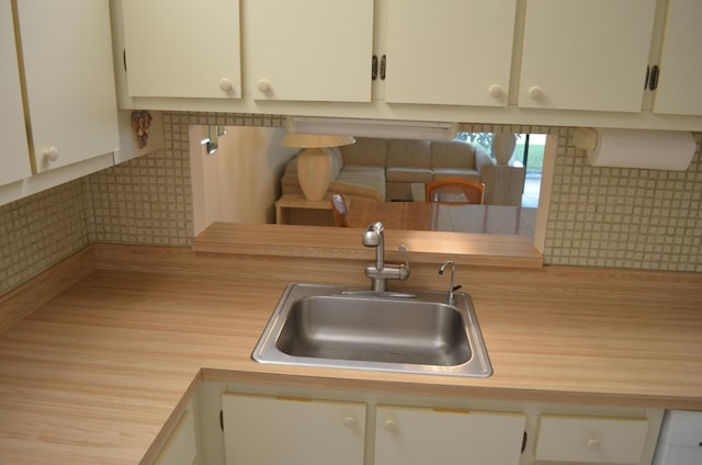 kitchen with a sink and white cabinets