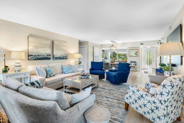 living room with visible vents and wood finished floors