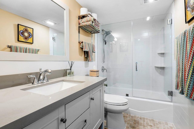 full bathroom with shower / bath combination with glass door, vanity, and toilet