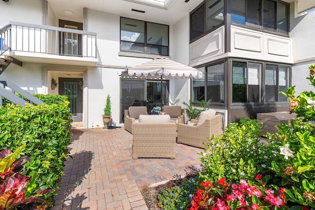 view of patio featuring a balcony and an outdoor living space