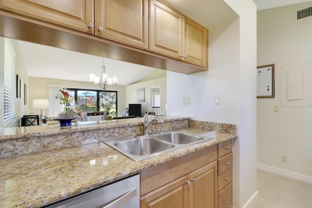 kitchen featuring baseboards, visible vents, light stone countertops, an inviting chandelier, and a sink