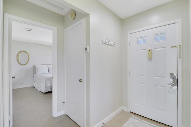 entrance foyer featuring light wood finished floors, baseboards, and visible vents