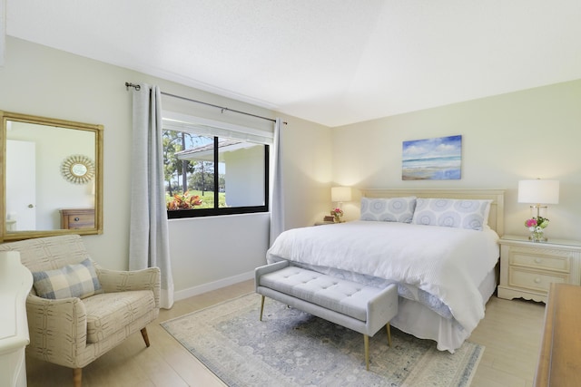 bedroom featuring baseboards and light wood finished floors