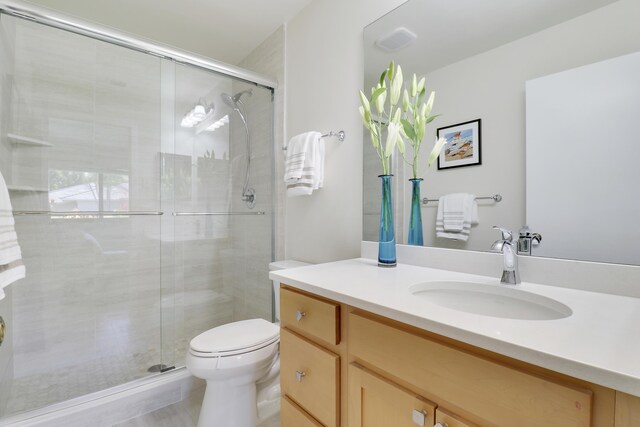 full bathroom featuring toilet, a shower stall, visible vents, and vanity