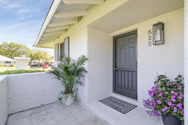 entrance to property with stucco siding