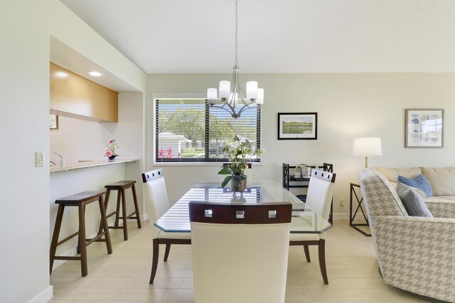 dining room featuring baseboards and an inviting chandelier